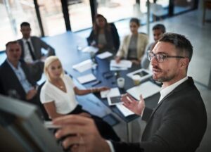 Man in a business meeting pointing on a monitor