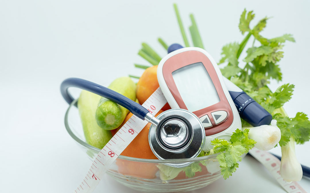 Close up of Stethoscope with Glucose meter for check blood sugar level, lancet, tape measure and green vegetable fresh tomato, cucumber coriander and scallion.