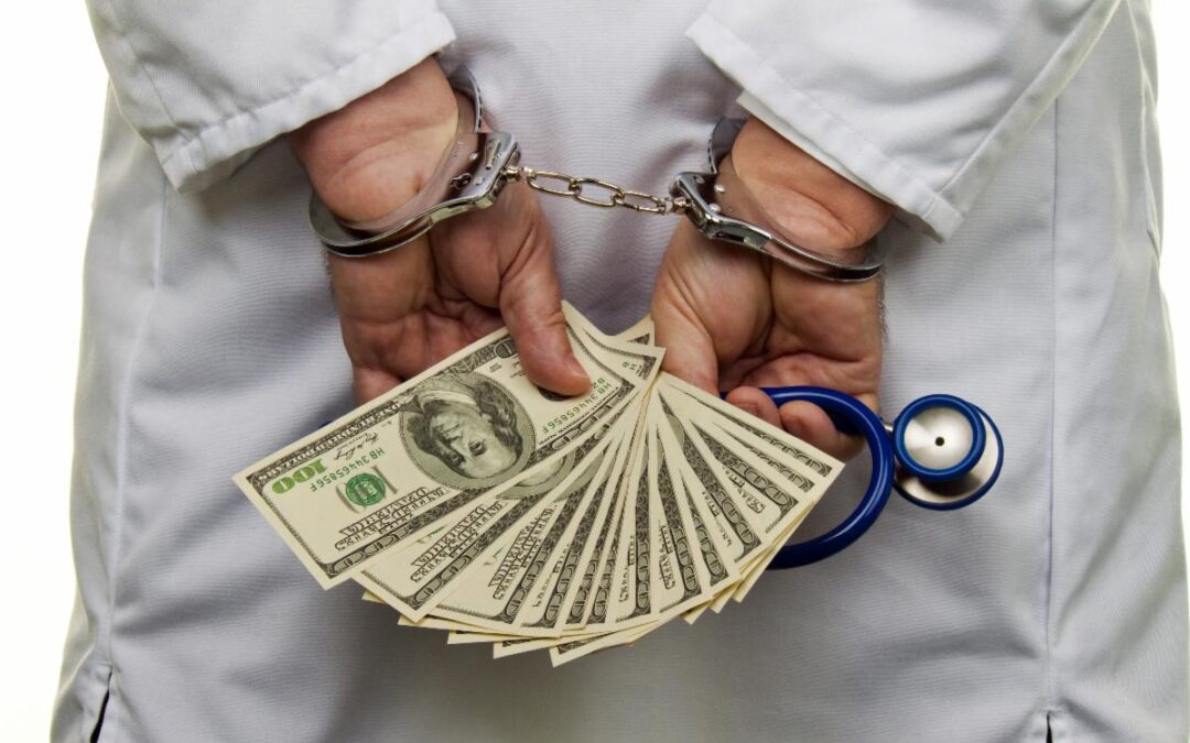 doctor-handcuffs-arrested-money