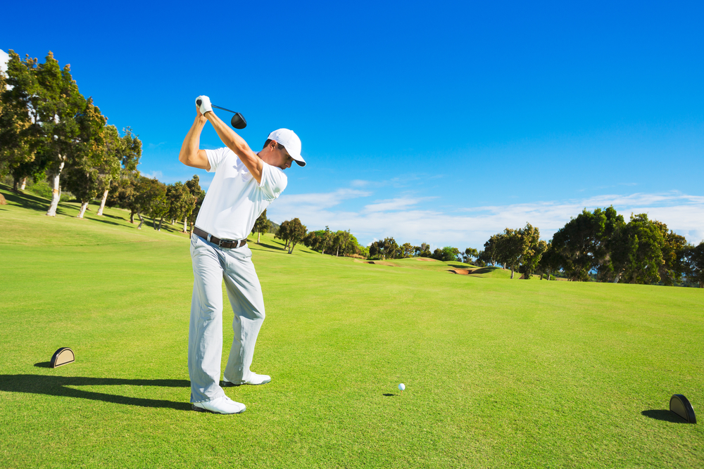 Golf,Player,Teeing,Off.,Man,Hitting,Golf,Ball,From,Tee