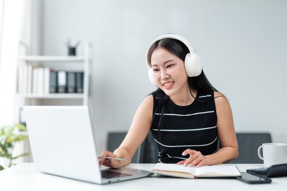 woman-watching-webinar-headphones